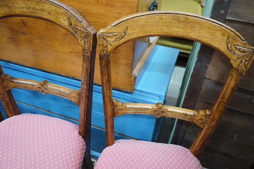 A late Victorian mahogany oval topped occasional table, width 75cm, height 71cm together with three Victorian oak dining chairs